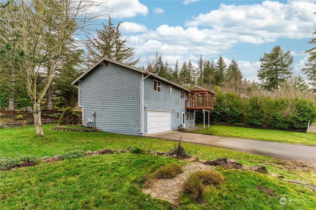 view of side of property with a lawn, a deck, and a garage