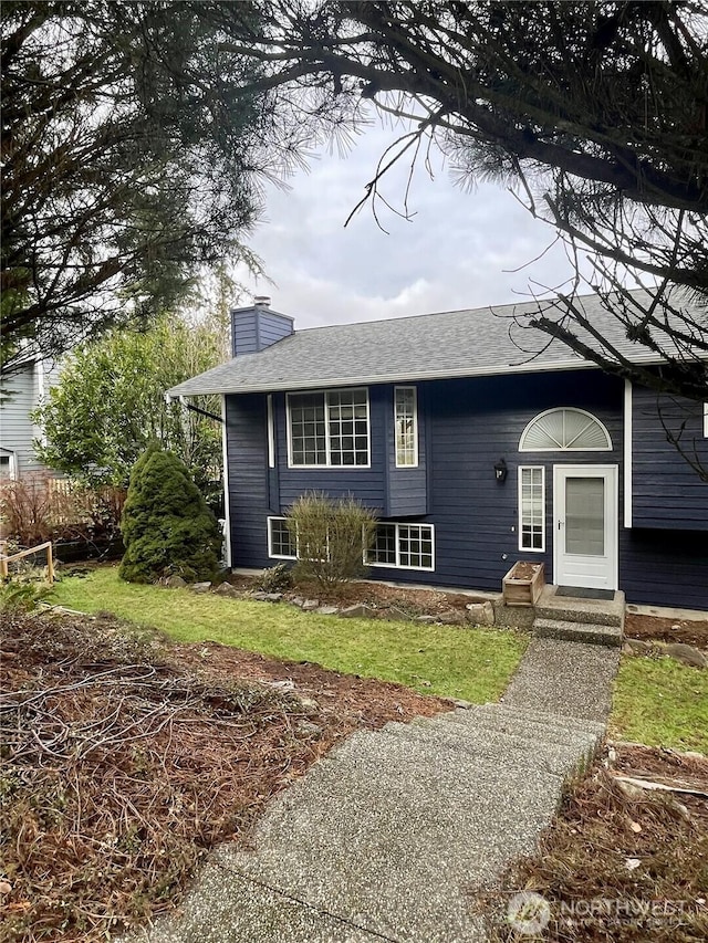 view of front of home featuring entry steps and a chimney