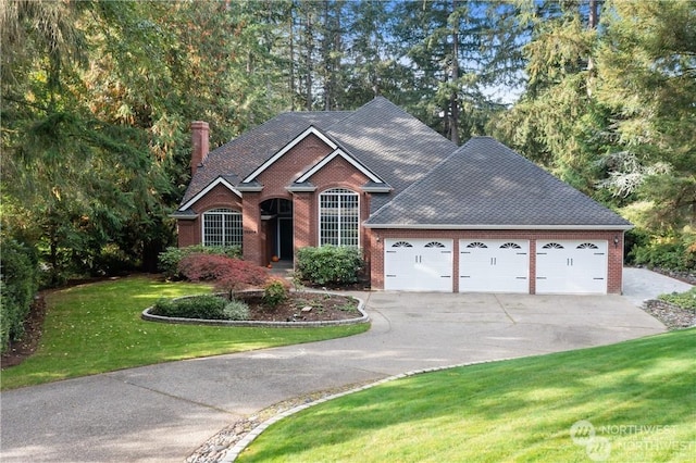 view of front of property featuring a garage and a front lawn