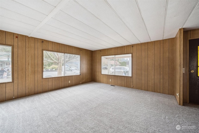 empty room featuring a textured ceiling and carpet