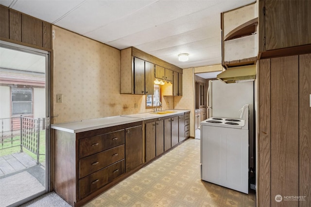 kitchen with white range with electric stovetop, extractor fan, and sink