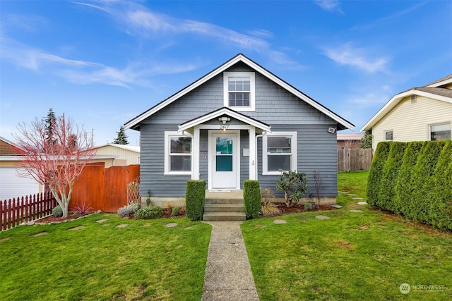 bungalow-style home with a front yard