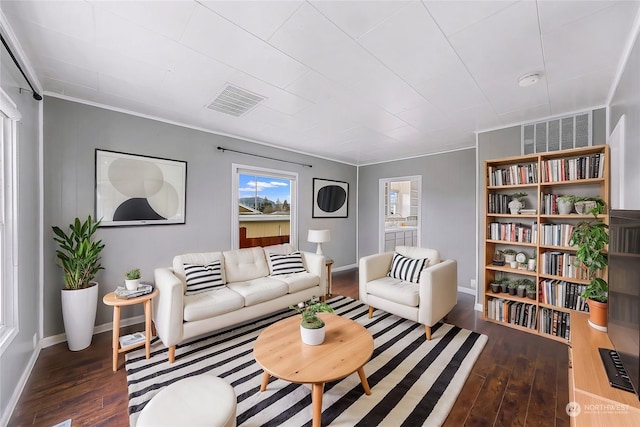 living room featuring dark hardwood / wood-style flooring and ornamental molding