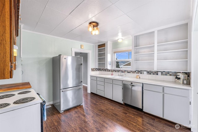 kitchen with stainless steel appliances, dark wood-type flooring, sink, white cabinetry, and backsplash