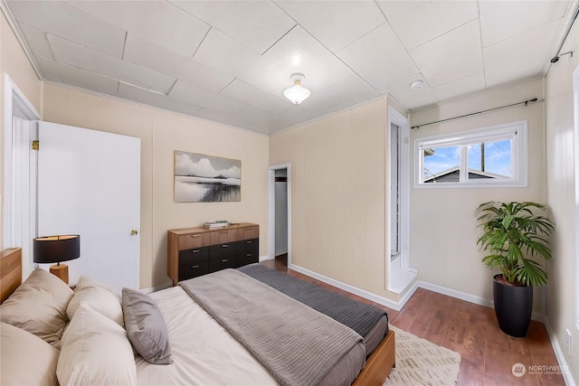 bedroom with crown molding and hardwood / wood-style floors