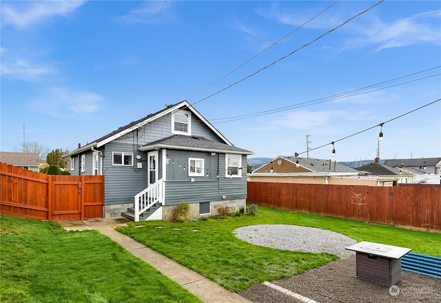 rear view of house with a yard