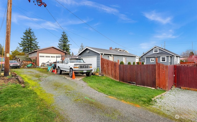 exterior space featuring a yard, a garage, and an outdoor structure