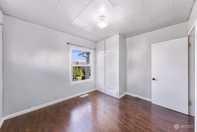 unfurnished room with dark hardwood / wood-style floors