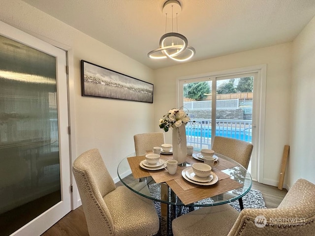 dining room featuring dark hardwood / wood-style flooring and an inviting chandelier