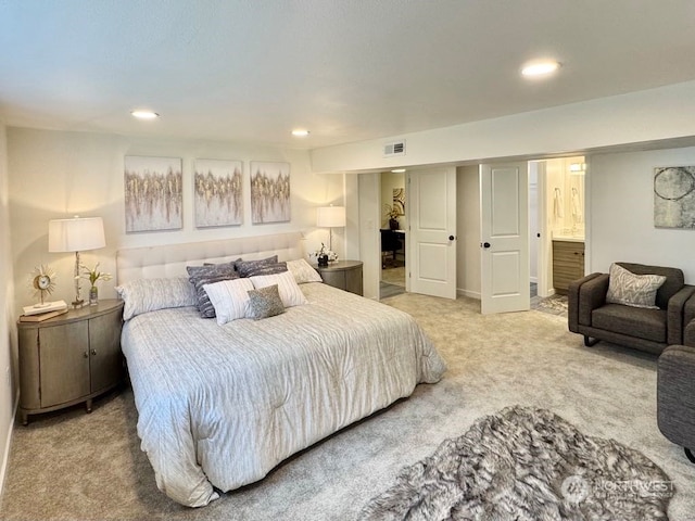 carpeted bedroom with ensuite bath