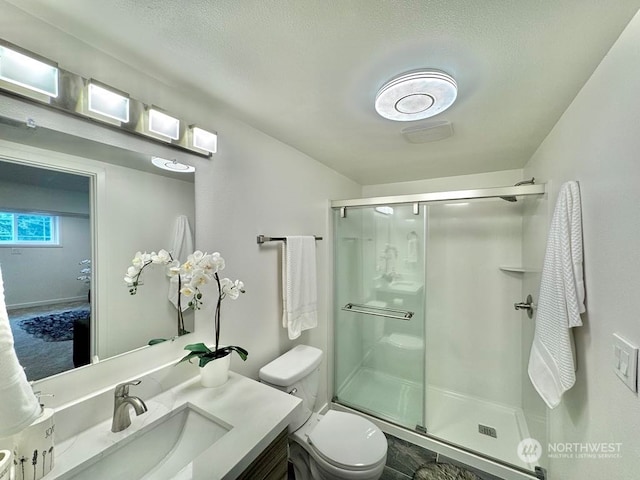 bathroom with toilet, walk in shower, and vanity