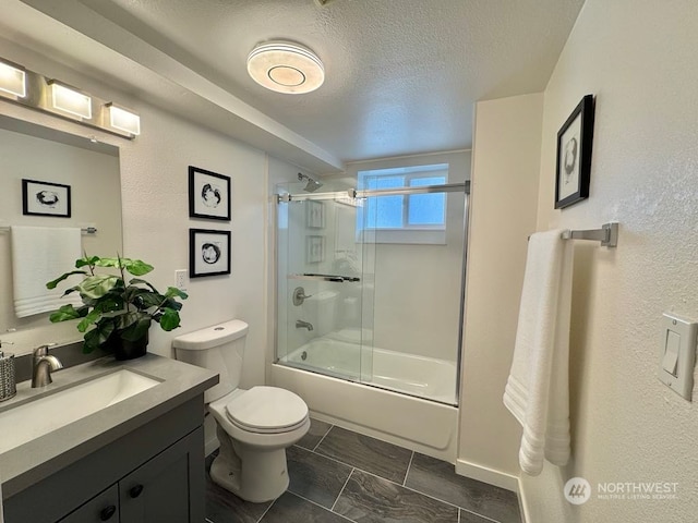 full bathroom featuring bath / shower combo with glass door, a textured ceiling, toilet, and vanity