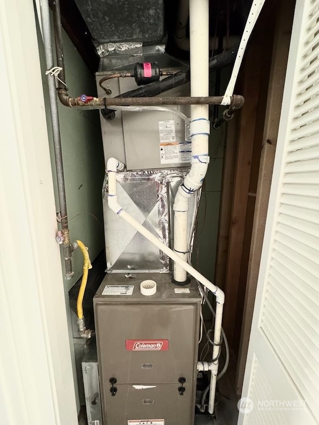 utility room featuring heating unit