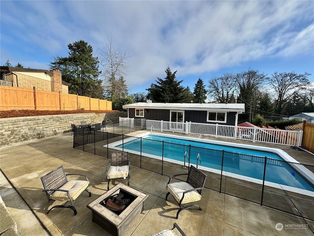 view of swimming pool with an outdoor fire pit and a patio area