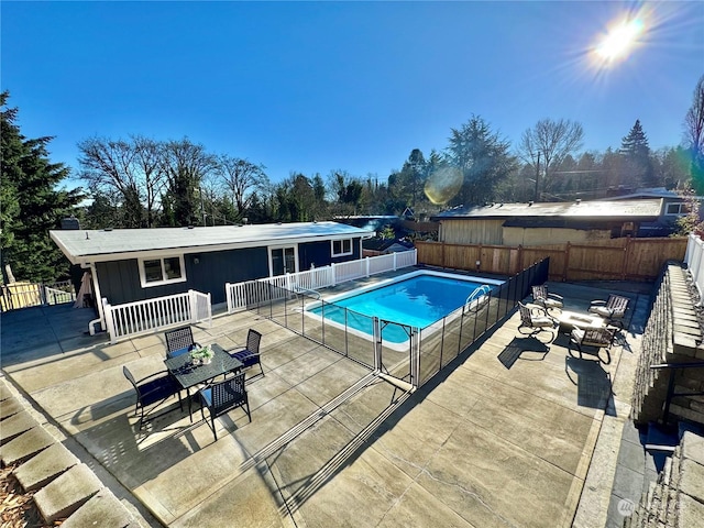 view of pool featuring a patio area and a fire pit