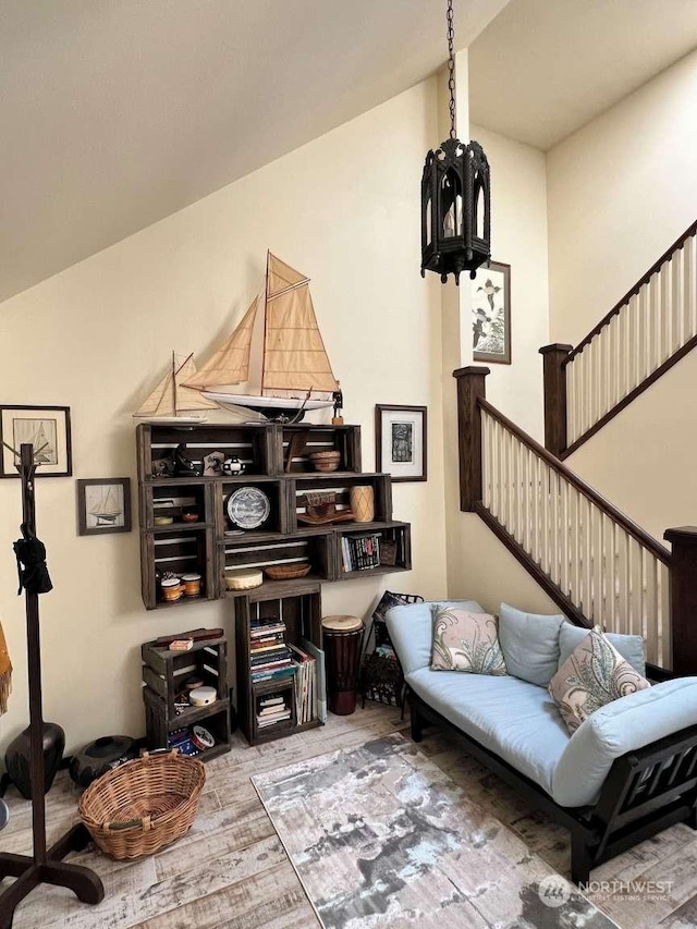 living area with wood-type flooring and lofted ceiling