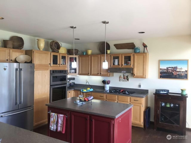 kitchen featuring appliances with stainless steel finishes, a center island, dark hardwood / wood-style floors, and hanging light fixtures