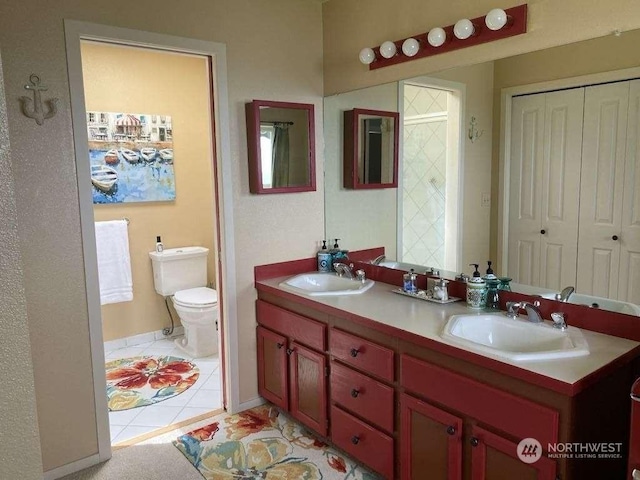 bathroom featuring tile patterned flooring, vanity, and toilet