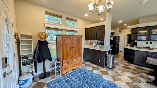 kitchen featuring a chandelier, pendant lighting, decorative backsplash, dark brown cabinetry, and black fridge with ice dispenser