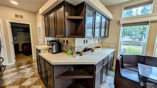 kitchen with backsplash and dark brown cabinetry