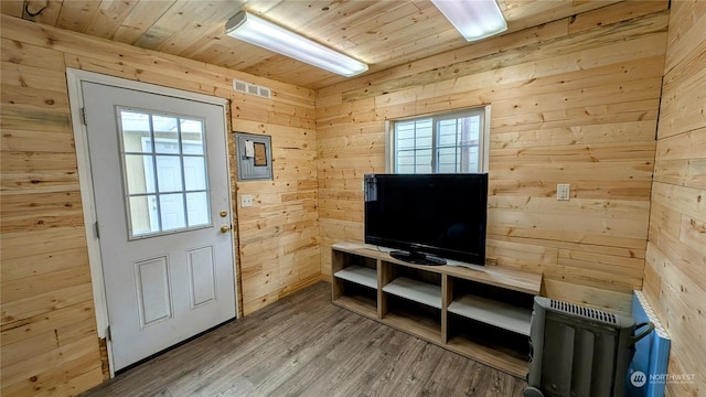 doorway to outside featuring wood ceiling, hardwood / wood-style floors, wooden walls, and plenty of natural light