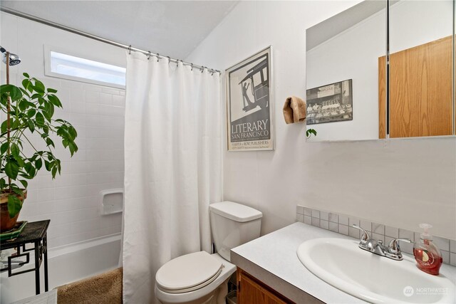 full bathroom with vanity, toilet, and shower / bath combo with shower curtain