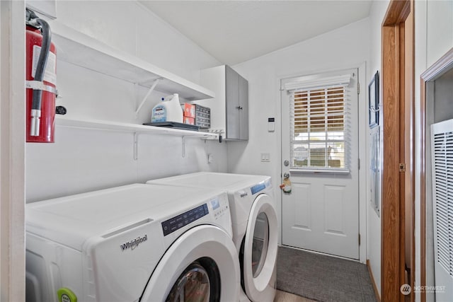 clothes washing area with washer and clothes dryer