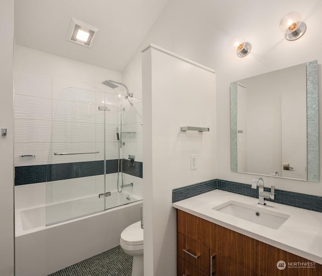 full bathroom with toilet, tile patterned flooring, enclosed tub / shower combo, and vanity