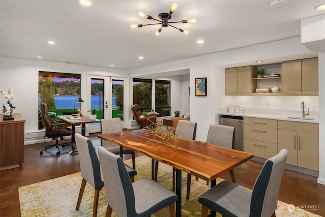 dining room featuring sink, french doors, and a notable chandelier