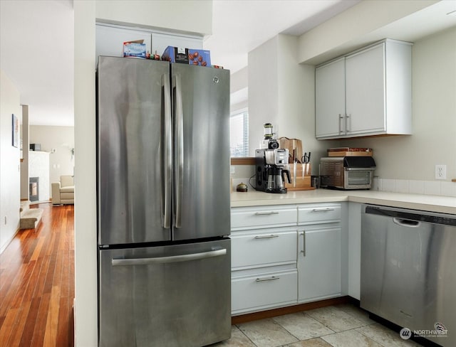 kitchen with appliances with stainless steel finishes and white cabinetry