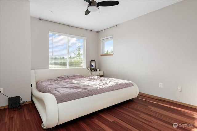 bedroom with ceiling fan and dark wood-type flooring