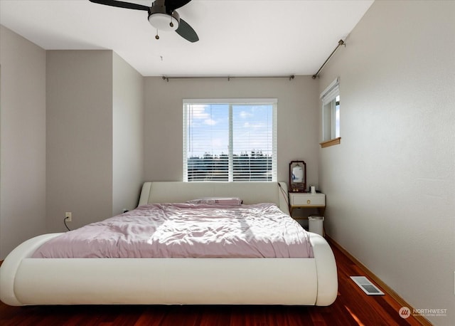 bedroom with ceiling fan and dark hardwood / wood-style floors