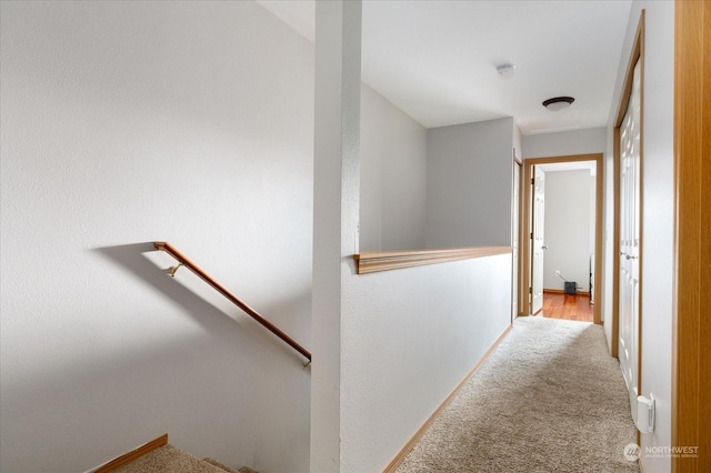 hallway with light colored carpet