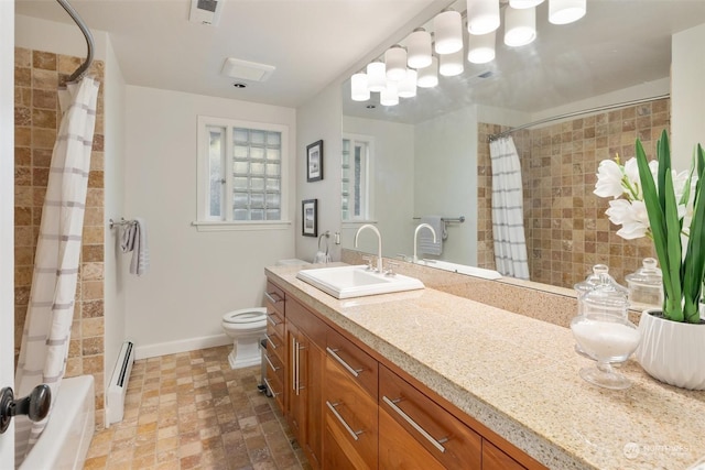 bathroom featuring baseboard heating, vanity, and toilet