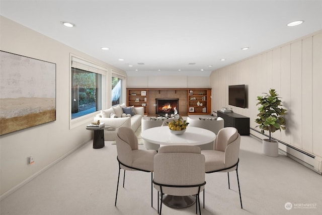 dining space featuring baseboard heating and light carpet