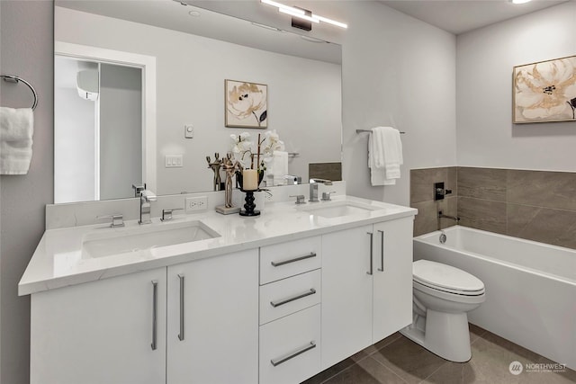 bathroom featuring vanity, tile patterned floors, toilet, and a bathing tub