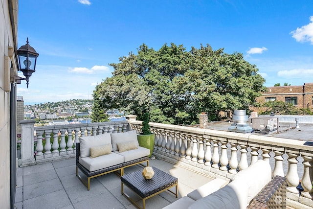 view of patio featuring an outdoor hangout area and a balcony