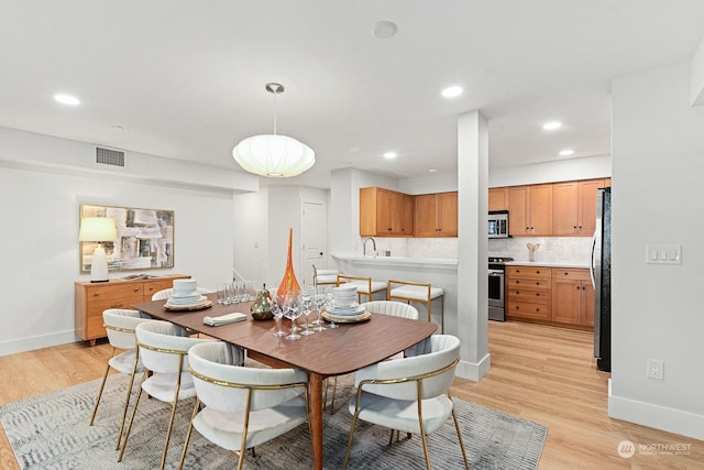 dining room with light hardwood / wood-style flooring