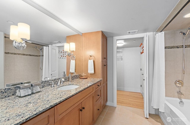 bathroom with tile patterned flooring, vanity, and shower / bath combo