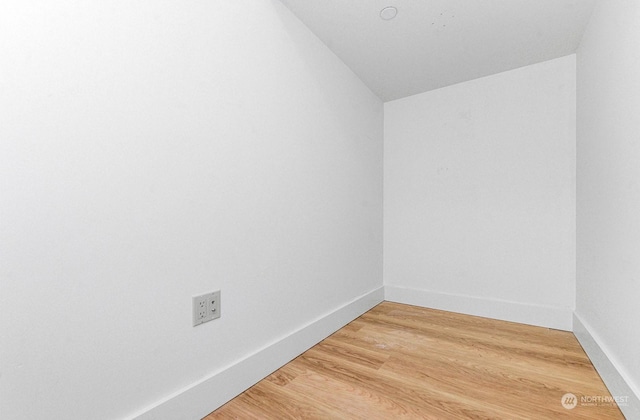 spare room with lofted ceiling and hardwood / wood-style floors