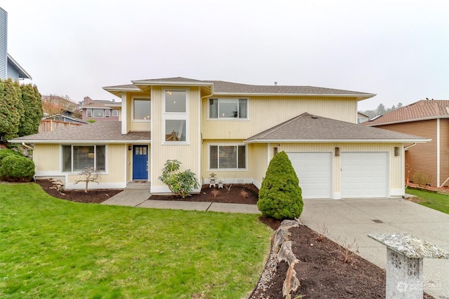 view of front of home with a front yard and a garage