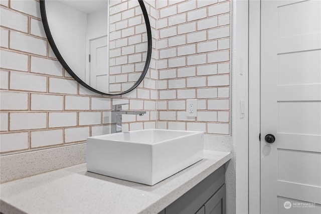 bathroom featuring tasteful backsplash and vanity