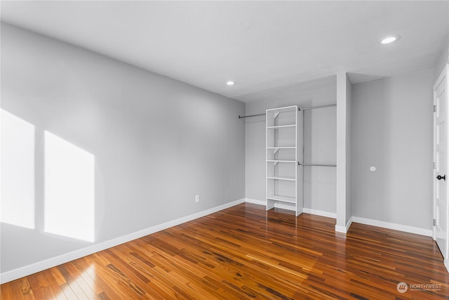 unfurnished bedroom featuring dark hardwood / wood-style flooring