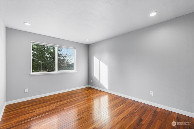 spare room with hardwood / wood-style floors