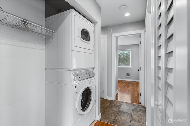 washroom featuring stacked washer / drying machine