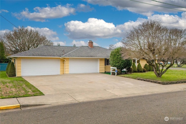 view of front of house featuring a front yard and a garage