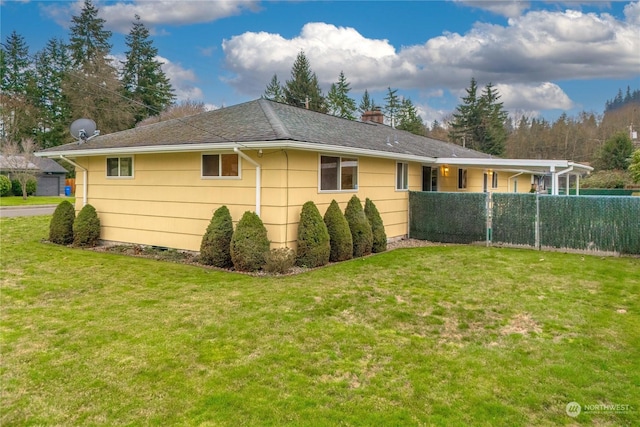 view of side of home with a yard