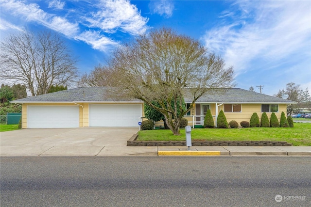 ranch-style house featuring a front lawn and a garage