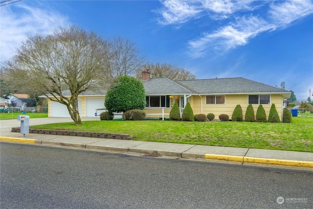 ranch-style house featuring a front lawn and a garage