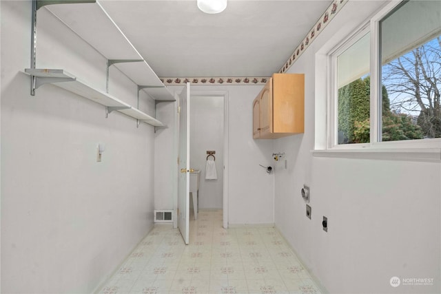 washroom featuring cabinets and electric dryer hookup